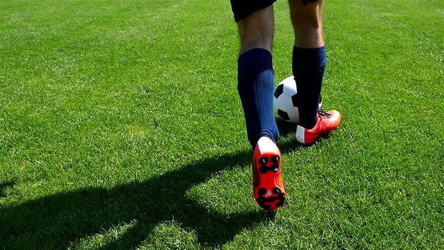 Footballer making tricks to avoid the defender, slow motion
