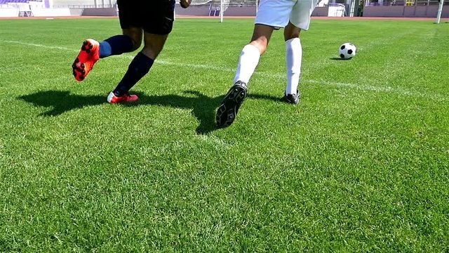 Footballer making tricks to avoid the defender, slow motion