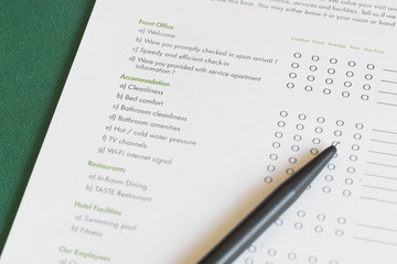 Close - up Hotel questionnaire form with pen