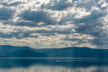 Light passes through the clouds on the lake Baikal