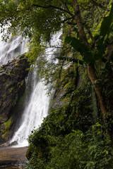 Fototapeta na wymiar Waterfall near trees.