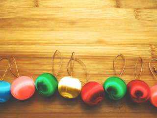 Colorful Christmas balls on wooden floor with light and color design and copy space