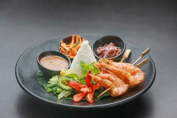 Skewered prawns with a portion of white rice