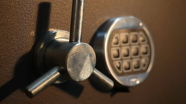 man opens the safe with a coded lock close up