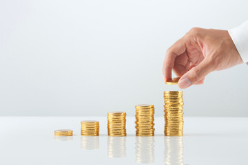 Hand putting stack of coins