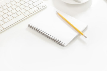 White office desk table with pen, notepad Top view with copy space. © bongkarn