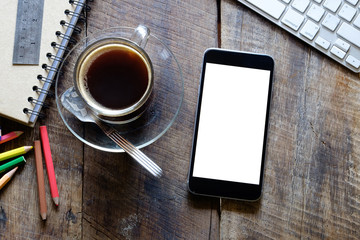 Smart phone with white blank empty screen on wood desk table in home office.