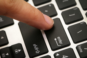 Finger pressing on ENTER button