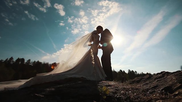 bride and groom kissing in the forest