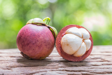 Fresh mangosteen on a wooden floor and has a background of natur