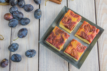 Top View on plum cake with cinnamon on small baking tray on whit