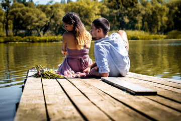 beautiful young couple on the pier near the river