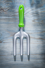 Stainless trowel fork on wooden board top view gardening concept