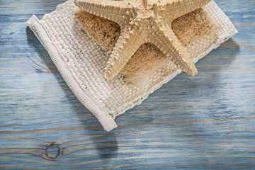 Starfish body scrubber on wooden board healthcare concept