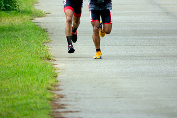 Sports background. Runner feet running on road