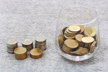 money in the glass with coin stack growing
