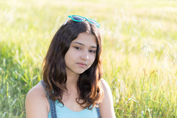 Portrait of sad teen girl on nature