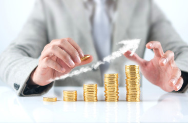 Hand putting stack of coins