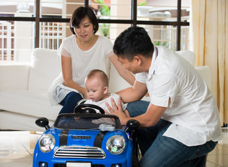 asian parent playing car with baby