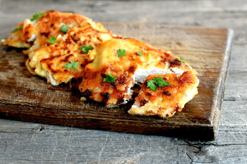 Fried Turkey chops in batter on a wooden board. Vintage style. Turkey chops recipe