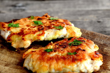 Turkey chops fried in batter. Delicious turkey chops on wooden board. Vintage style. Macro