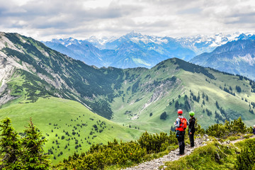 Fototapeta na wymiar Hiker in beautiful landscape of Alps in Germany - Hiking in the