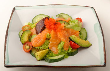 Raw salmon, avocado, tomato and lettuce salad.