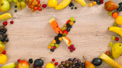 Fruits made letter X. Alphabet on a table. Fruits are forming letters. X