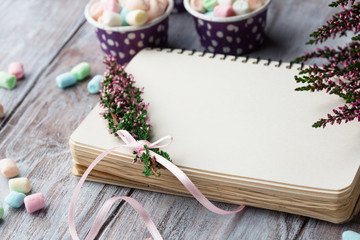 Empty paper note and fresh heather flowers calluna vulgaris