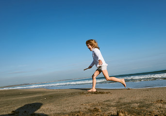Fototapeta na wymiar boy running at the Beach