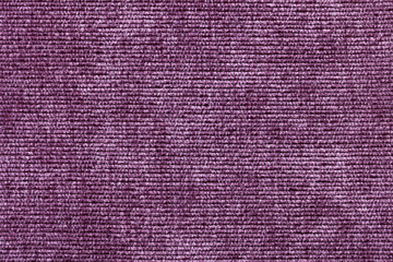 Purple background from soft textile material. Fabric with natural texture.