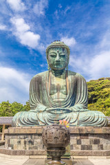 The Great Buddha in Kamakura. Pigeon is resting on top of the Buddha's head.