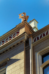 Sculpture boy with a book on the roof