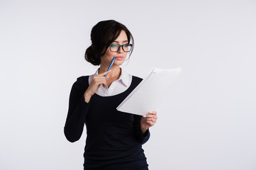 Thoughtful woman with papers standing isolated on a white background