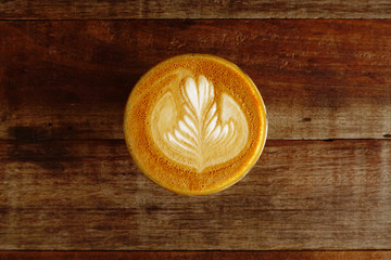 Fototapeta na wymiar cup of latte art coffee on wooden background