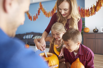 Fototapeta premium Family working on Halloween pumpkins