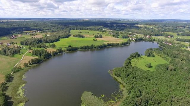 View of small islands on the lake in Masuria and Podlasie district, Poland. Blue water and whites clouds. Summer time. View from above.