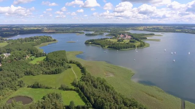 View of small islands on the lake in Masuria and Podlasie district, Poland. Blue water and whites clouds. Summer time. View from above.