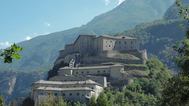 Bard, Aosta valley, Italy. View of fortified ancient complex Fort Bard with mountains landscape. Tourist attraction, museum and art gallery. Summer holidays, history and italian tourism destination