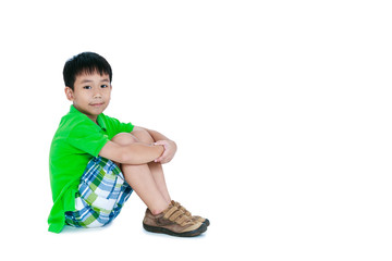Side view of asian child smiling and looking at camera. Isolated