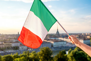 Italian flag on the Turin cityscape background in Piedmont region in Italy