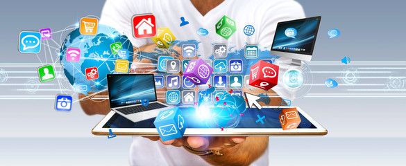 Businessman holding multimedia tech devices in his hand