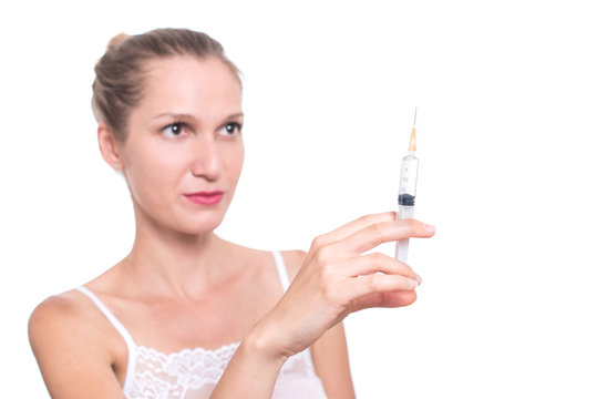 Syringe. Woman holding medical injection in hand, palm or finger