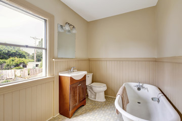 Traditional bathroom interior with tube and tile floor
