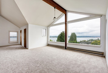 Empty hallway interior with carpet floor, big window and perfect water view