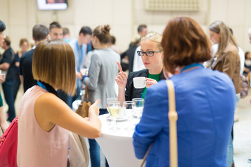 People interacting during coffee break at medical or scientific conference.