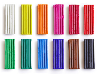 Set of colorful plasticine sticks isolated on white background. Rainbow modeling clay piece for children play and creativity.