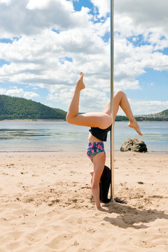 performing acrobatic dancer from pole on background