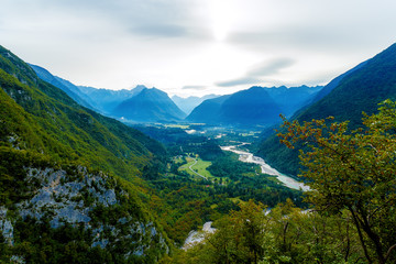 Obraz premium Rivers in the valley and hills in the background. Soca River in Slovenia.