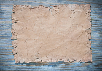 Vintage sheet of paper on wooden board